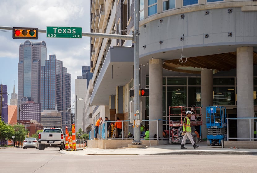Downtown can be seen in the background of the Tom Thumb being built at Live Oak and Texas...