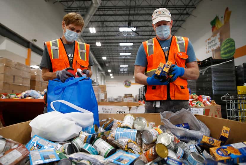 Volunteers Jill Mendenhall and her husband Max Chesser of Frisco work on sorting and...