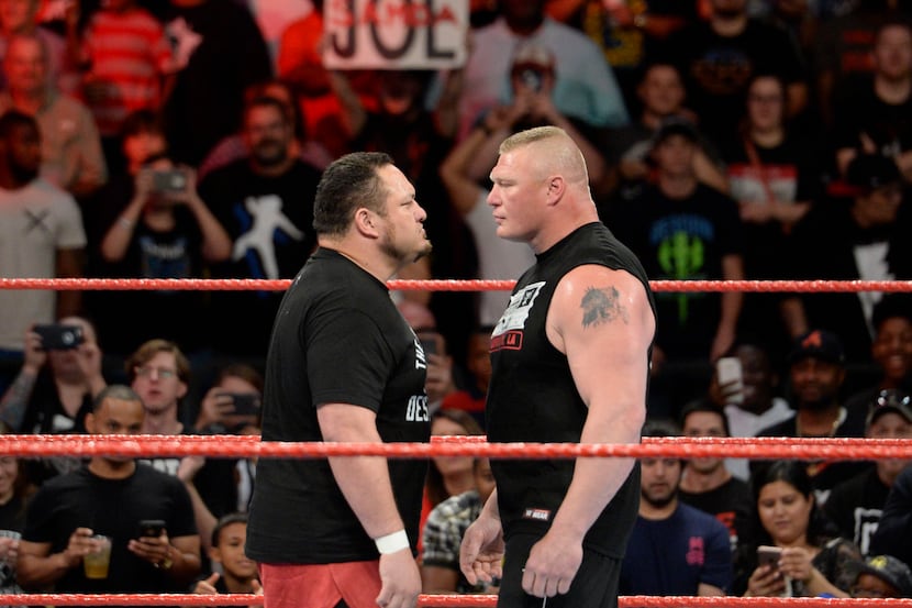 No. 1 contender Samoa Joe (left) stares down WWE universal champion Brock Lesnar (right) on...
