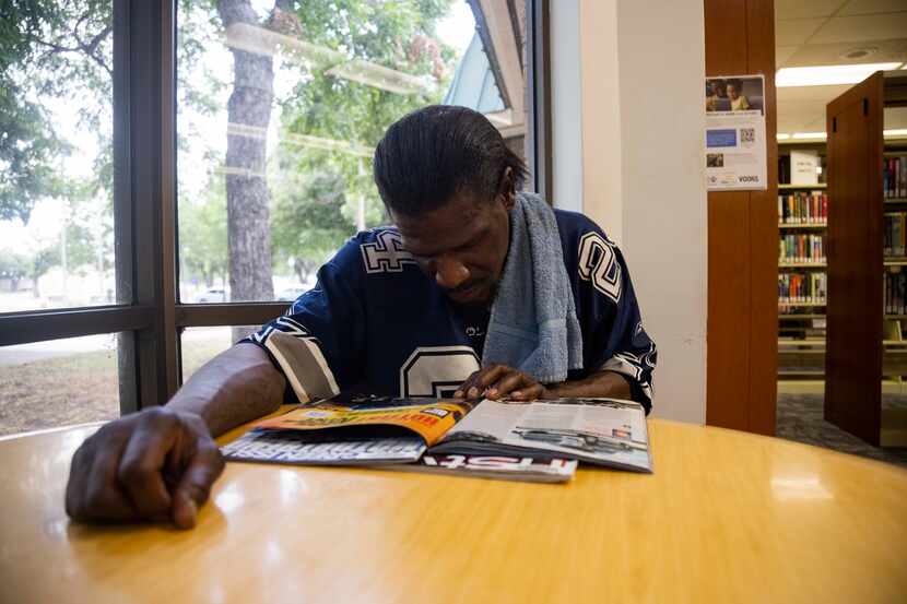 Ervin Jones reads a magazine at the Martin Luther King Branch Library located at the Martin...