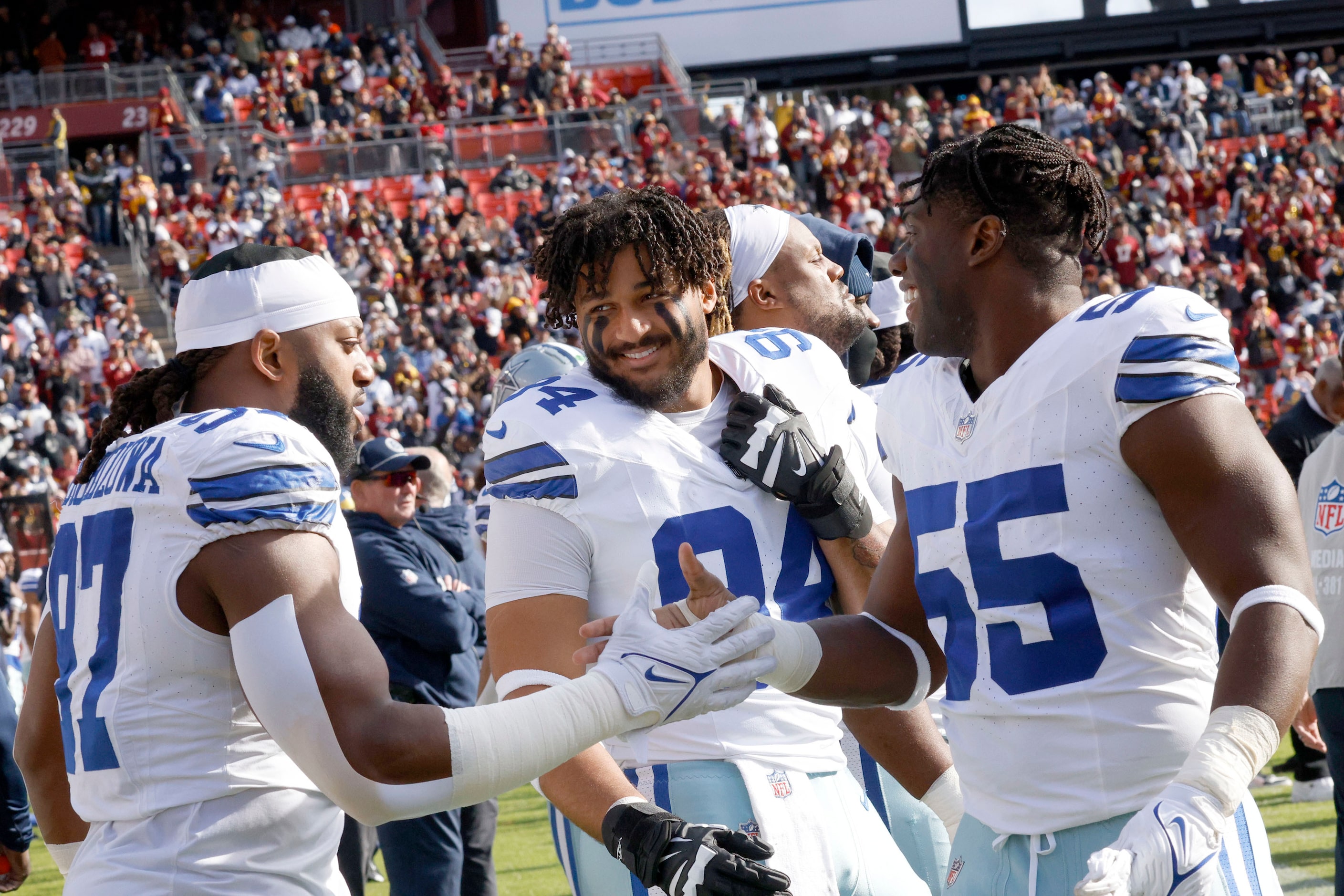 Dallas Cowboys defensive end Marshawn Kneeland (94) talks with his teammates Dallas Cowboys...