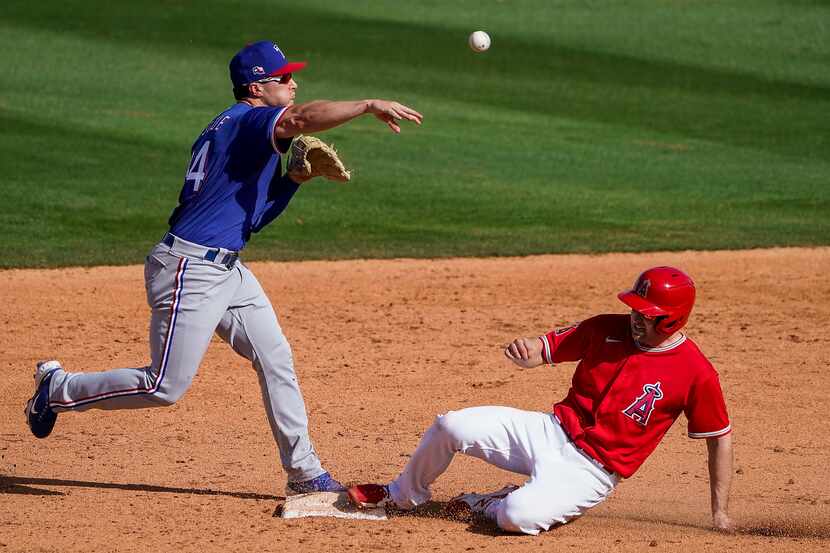 Texas Rangers second basema Justin Foscue makes the relay over Los Angeles Angels second...