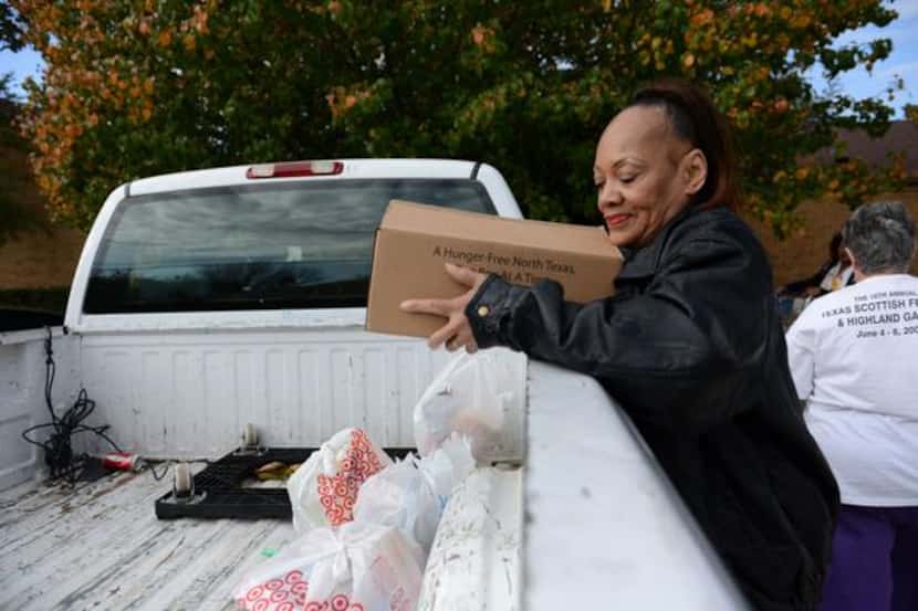 
Mona Hill helps load food for her sister-in-law at Oak Cliff Churches for Emergency Aid.
