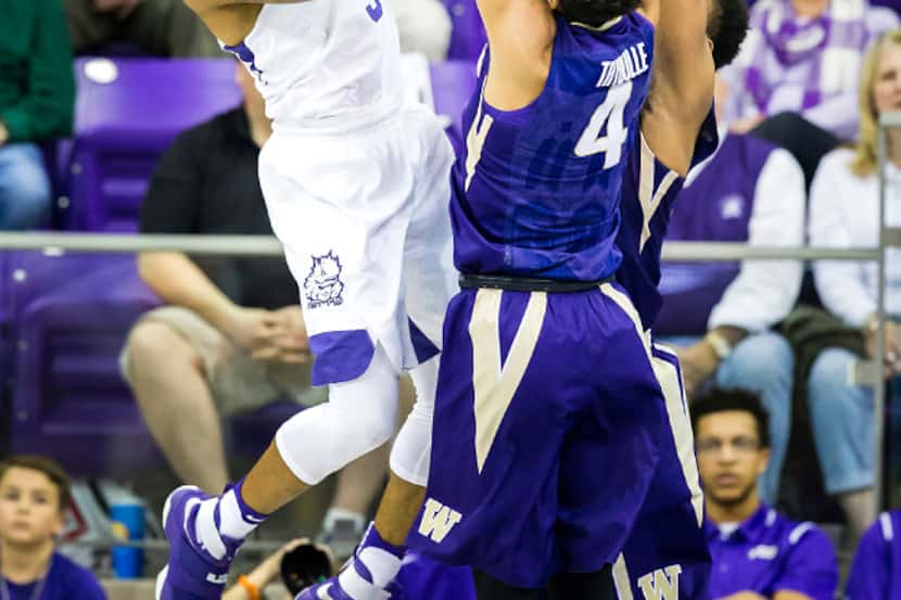 TCU guard Malique Trent (3) shoots over Washington forward Matisse Thybulle (4) during the...