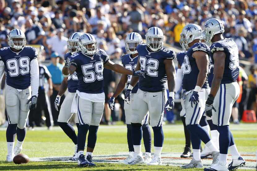The Dallas Cowboys defense led by middle linebacker Anthony Hitchens (59) huddles up against...
