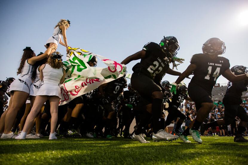 Mansfield Lake Ridge enter the field before a high school football game between Lancaster...