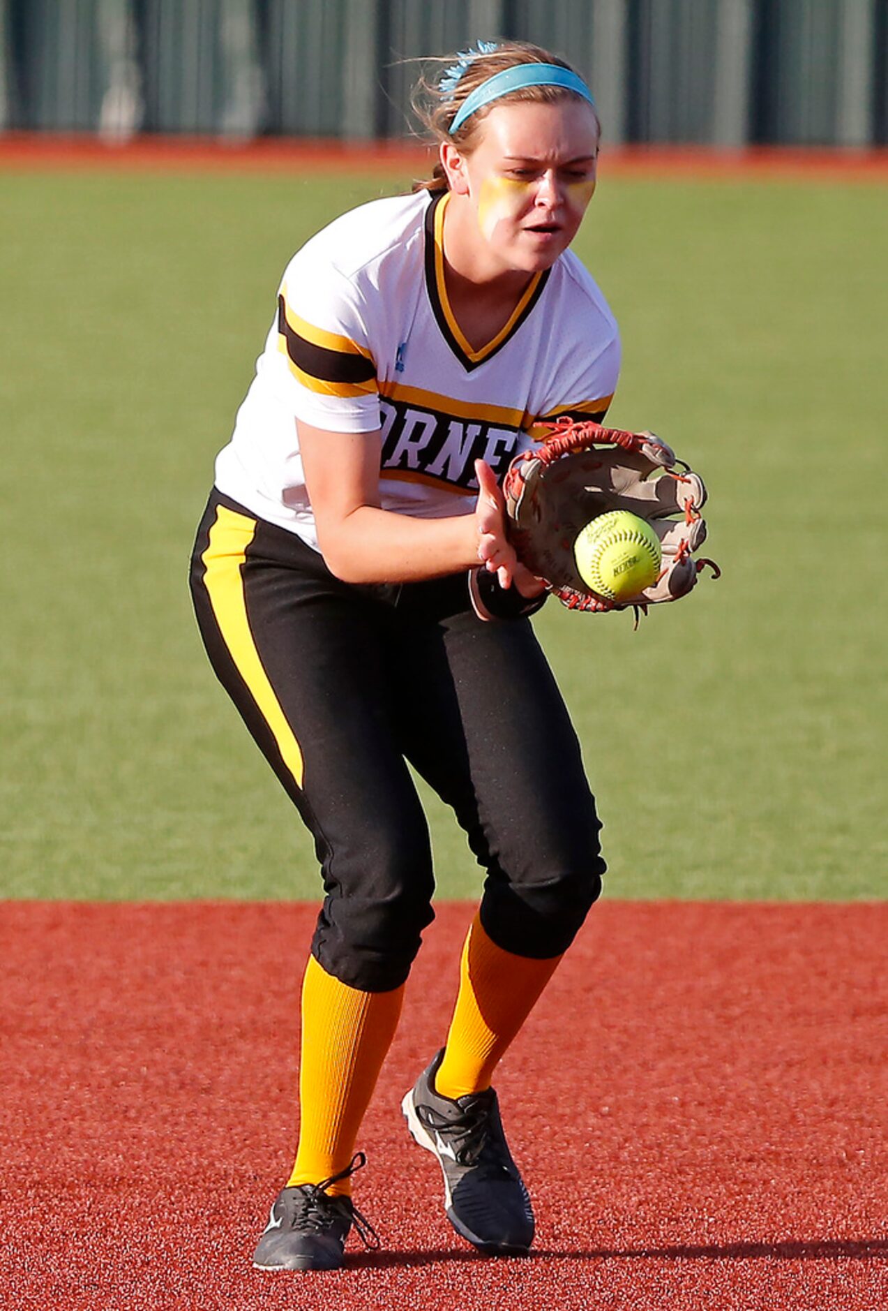 Forney High School shortstop Caleigh Cross (23) fields a grounder on a high bounce in the...