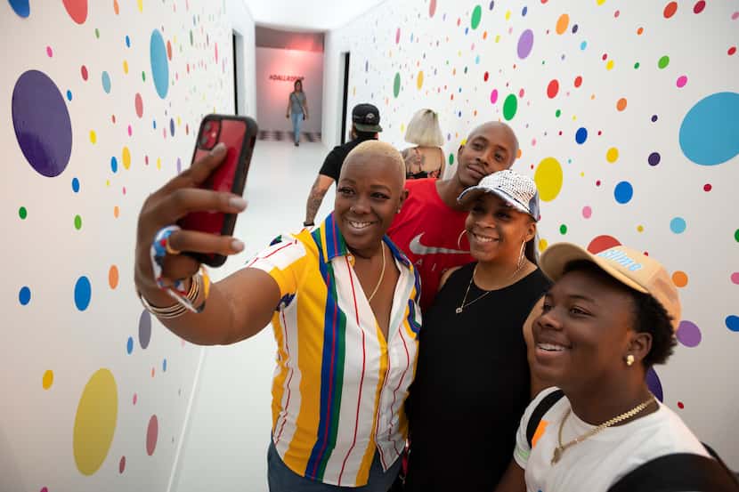 Yolanda Miller snaps a selfie with Tyvone Barnes (in red), Tanika Myricks (second from...