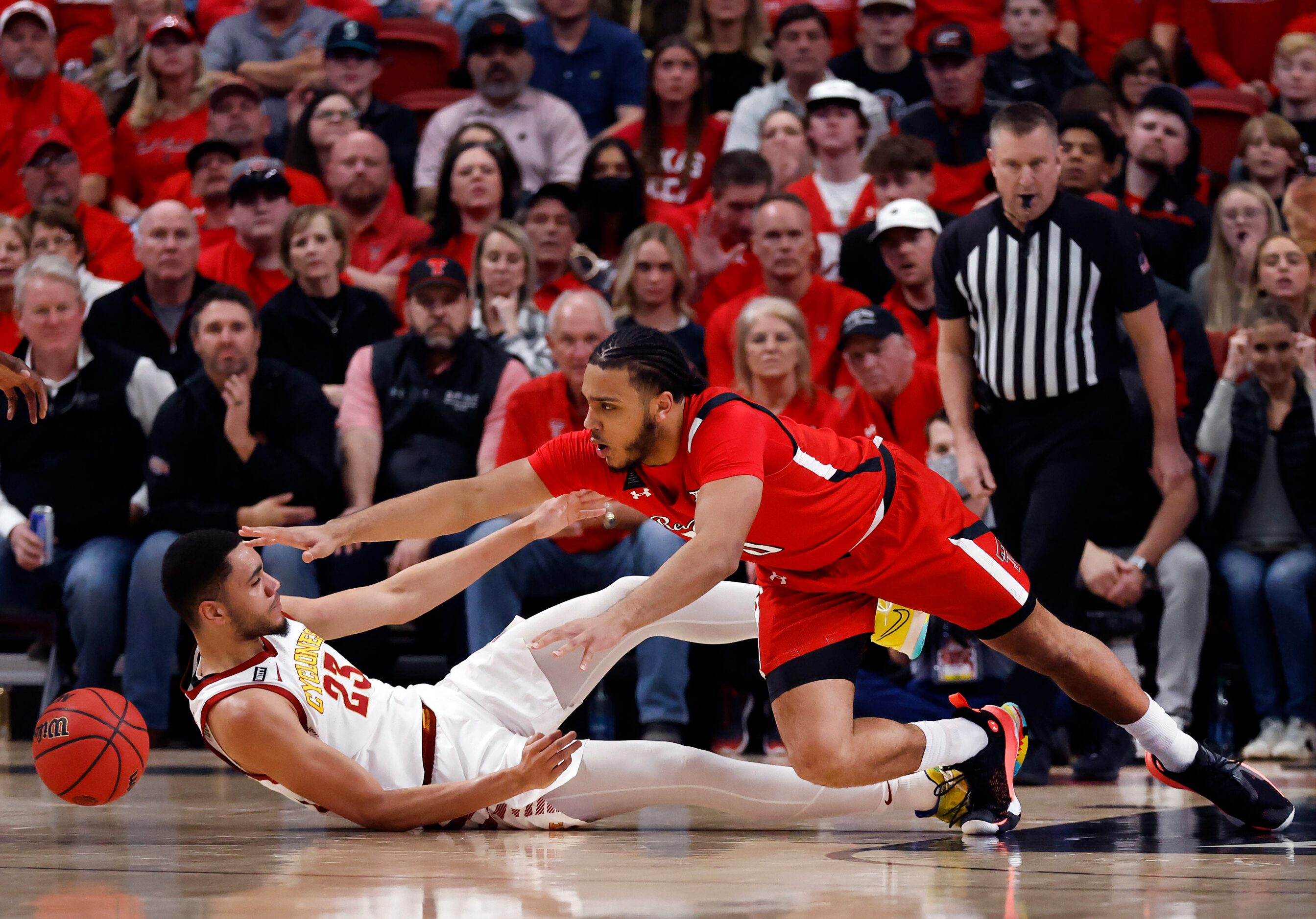 Texas Tech Red Raiders forward Kevin Obanor (0) dives for a loose ball over Iowa State...