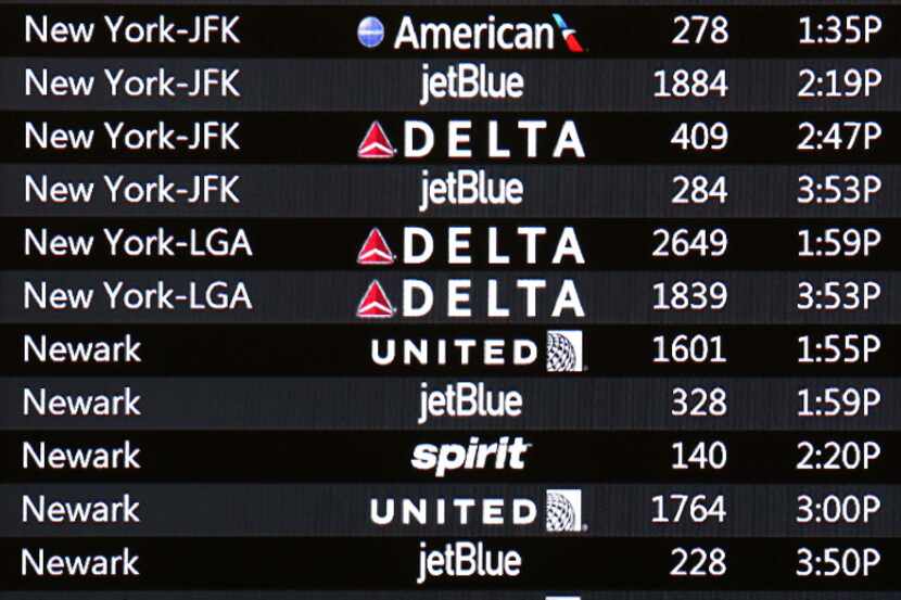 A flight status board at Orlando International Airport shows a few of the hundreds of...