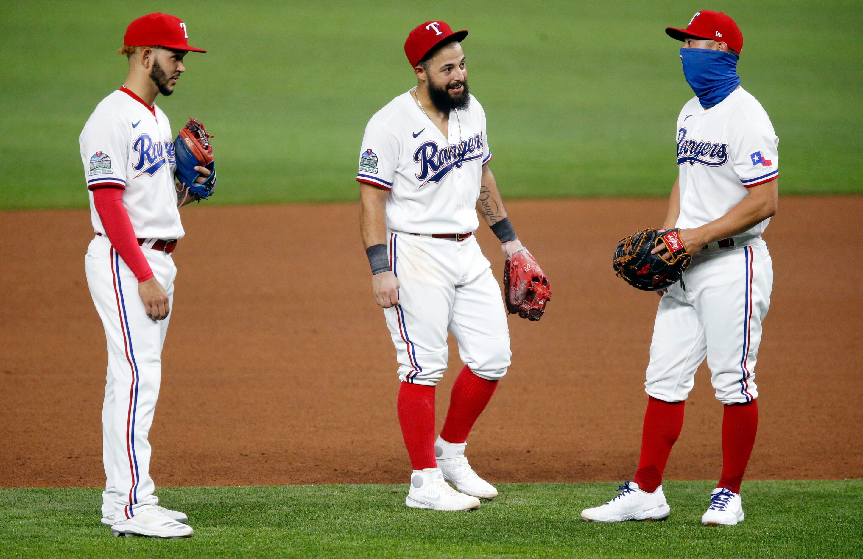 Texas Rangers second baseman Rougned Odor (center) visit with teammates Rob Refsnyder...