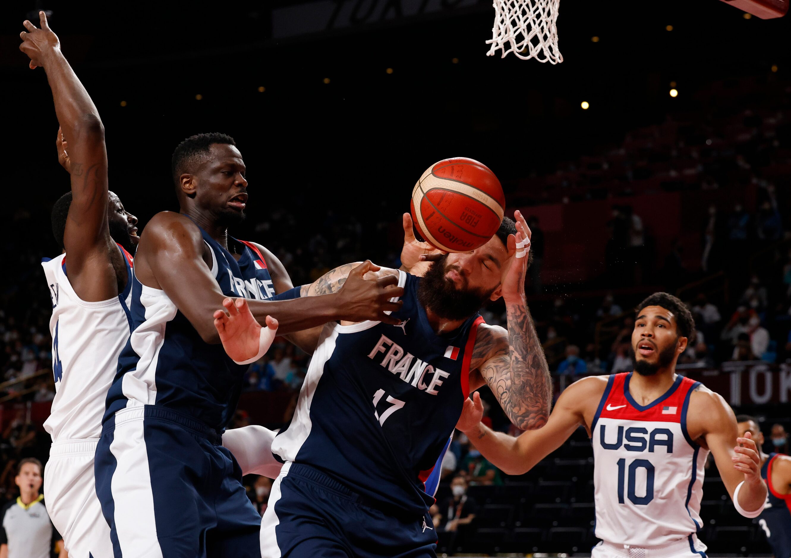 The ball bounces off of France’s Vincent Poirier (17) as teammate Moustapha Fall (93)...