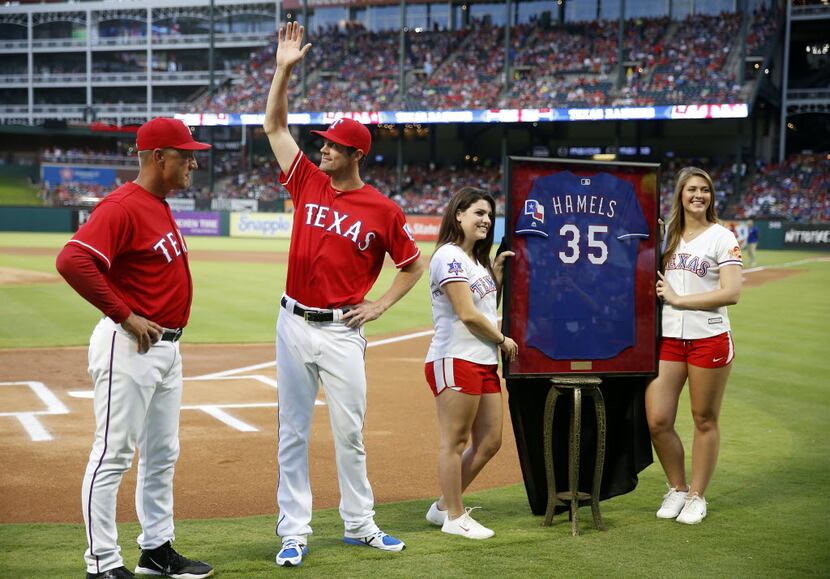 Texas Rangers starting pitcher Cole Hamels (second from left) waves to the fans next to...