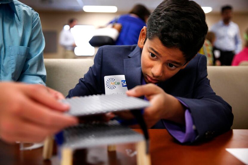 
Eighth-grader Sahil Mane of Frisco’s Pearson Middle School works on a standing-desk model...