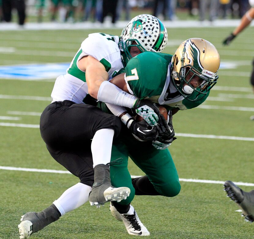 DeSoto High WR Rickey Daniels (7) fights to get his reception into the end zone past...