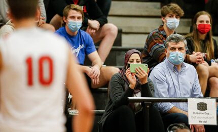 Maher, right, and Fatima Shamait, left, watch their son, Lake Highlands senior forward...