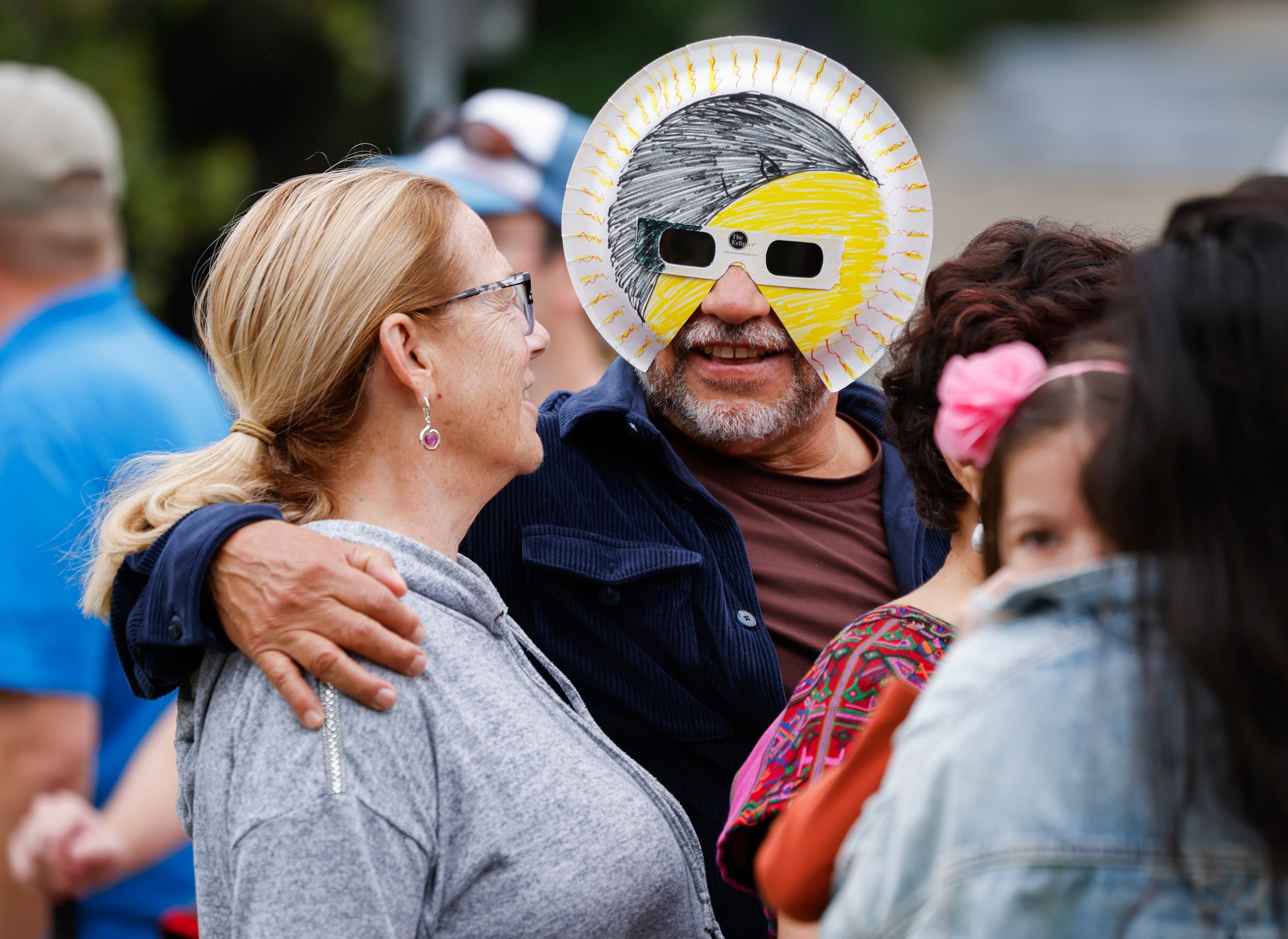 (From left) Bette Perez of New Orleans looks at husband Alfredo Perez, who is wearing...