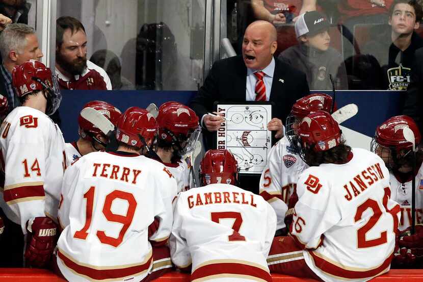 Denver coach Jim Montgomery talks to his team during the third period of the NCAA Frozen...