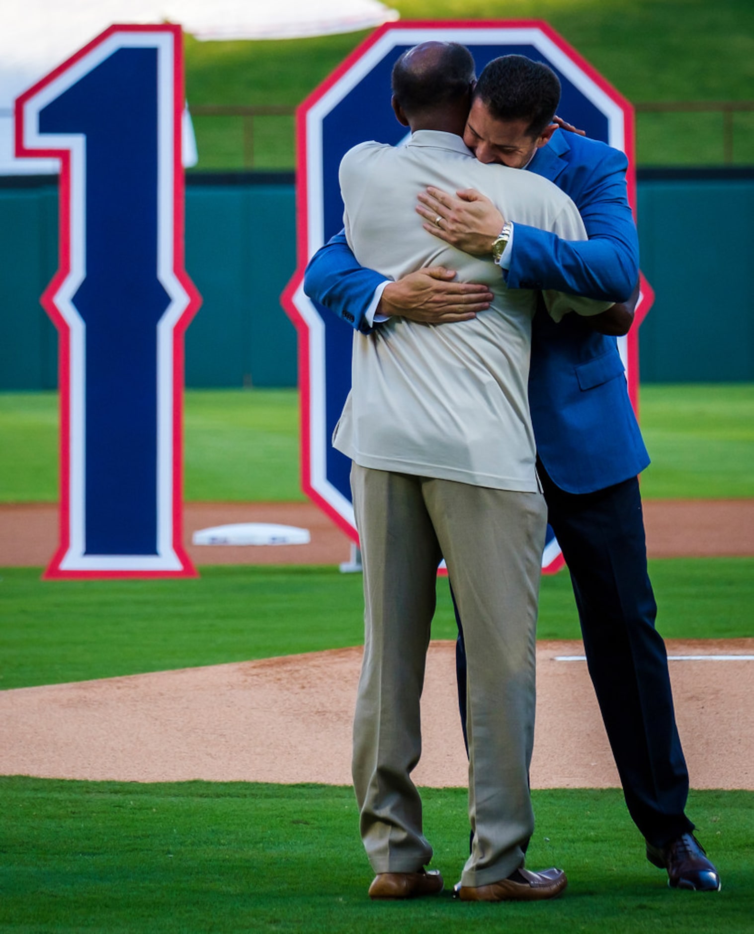 Michael Young hugs former Texas Rangers manager Ron Washingtong during ceremonies to retire...