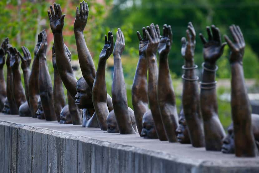 The bronze statue "Raise Up" is part of the display at the National Memorial for Peace and...