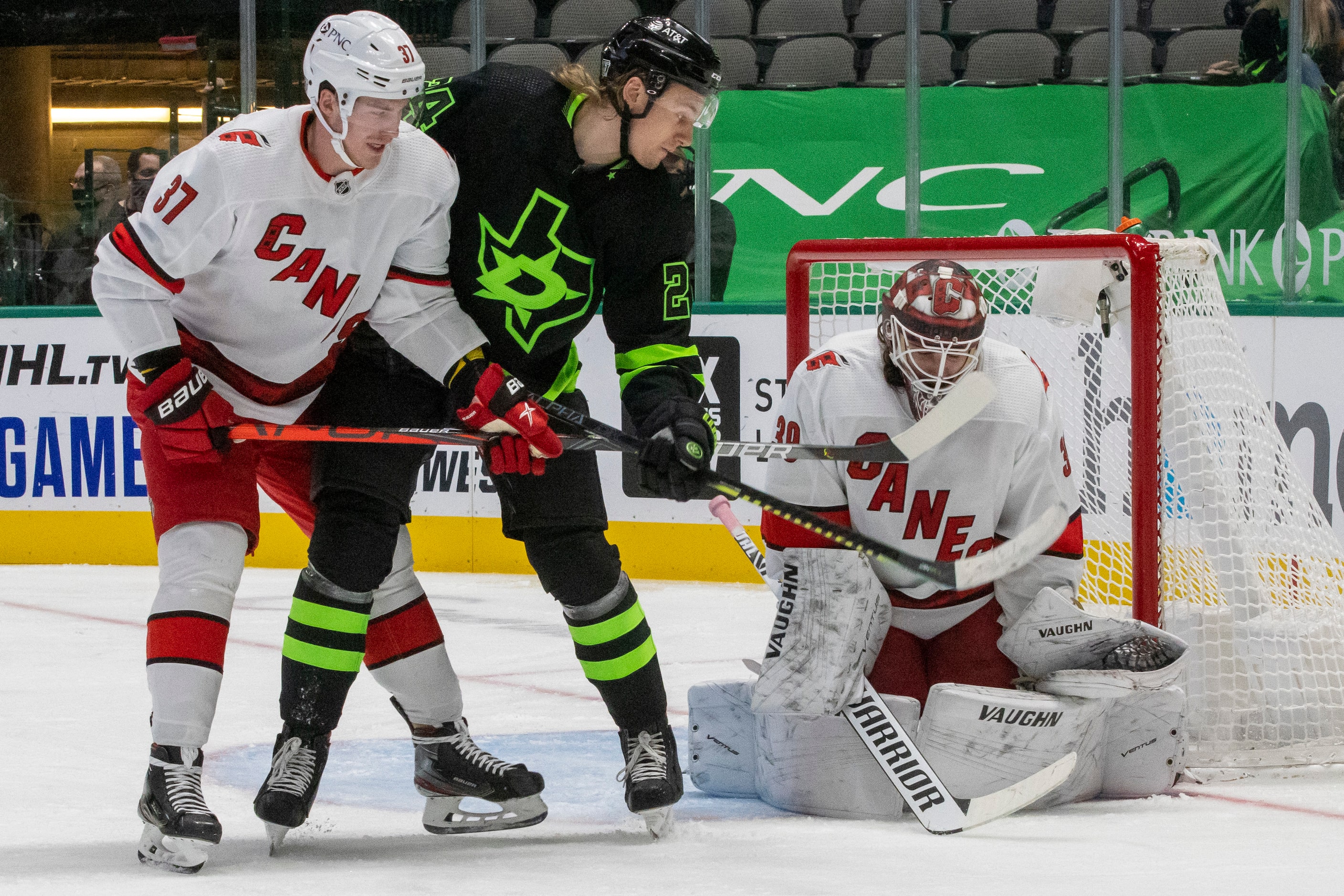 Dallas Stars left wing Roope Hintz (24) struggles against Carolina Hurricanes right wing...