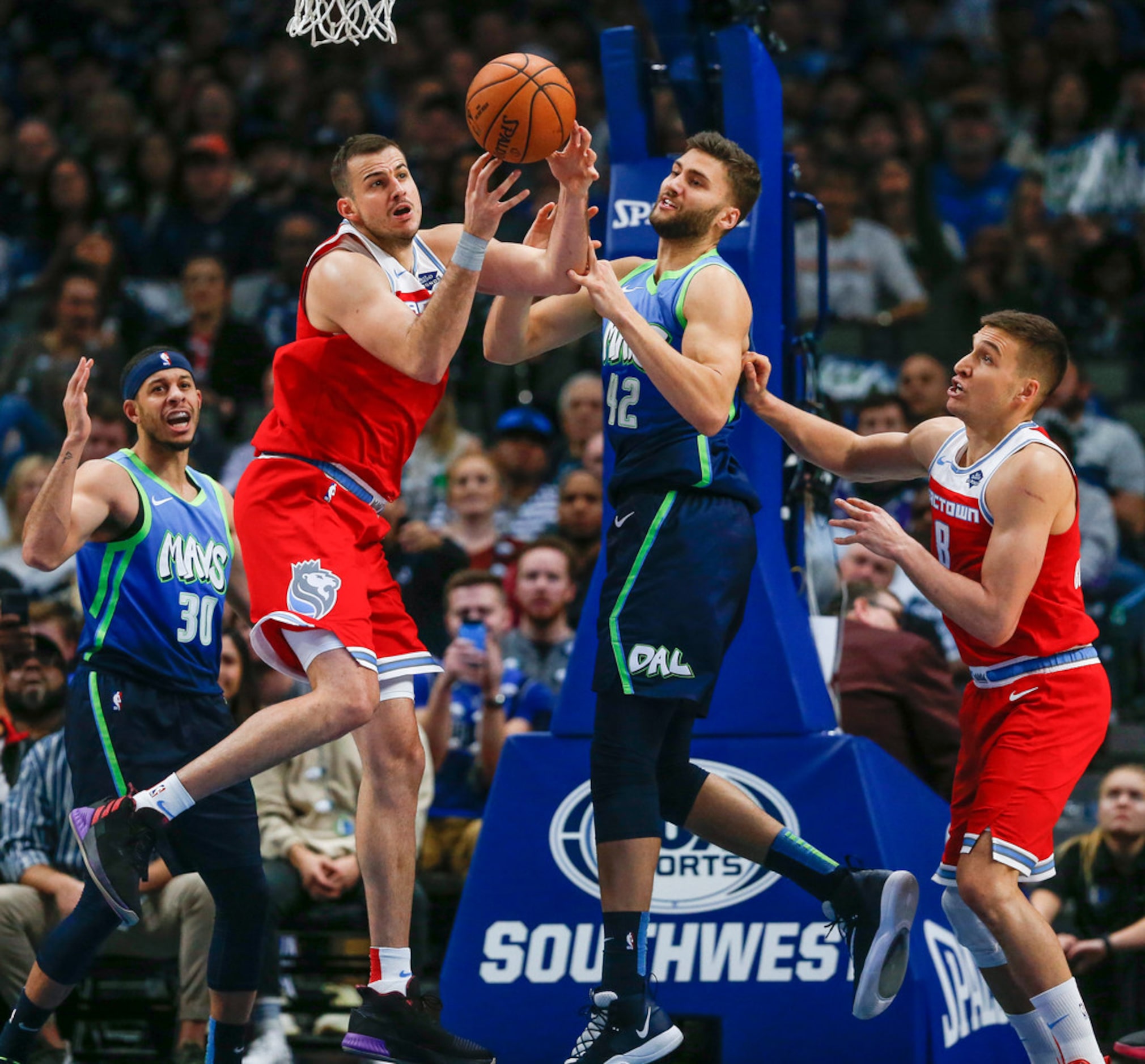 Dallas Mavericks forward Maxi Kleber (42) and guard Seth Curry (30) battle for a rebound...