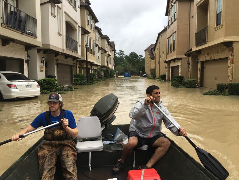 Dallas residents Josh Womack and Sammy Abdullah paddled through a row of townhomes on a...