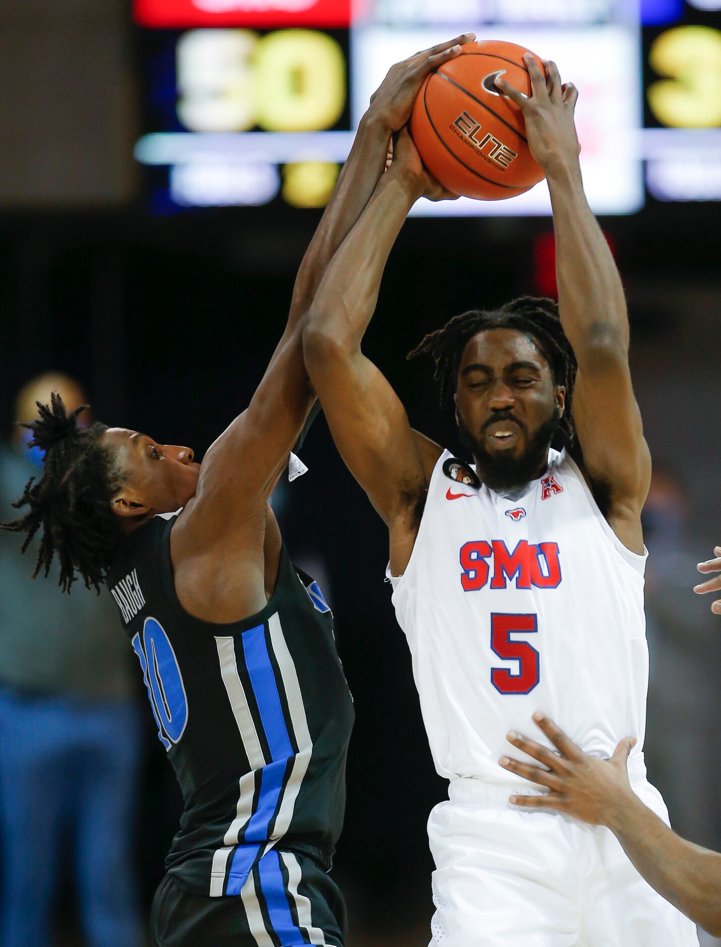 SMU guard Emmanuel Bandoumel (5) battles Memphis guard Damion Baugh (10) for space during...