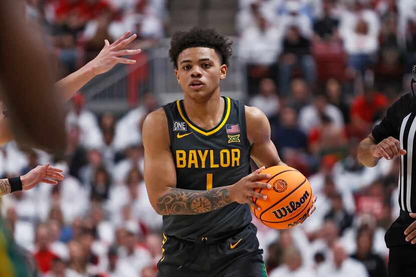 Baylor's Keyonte George (1) passes the ball during the second half of an NCAA college...