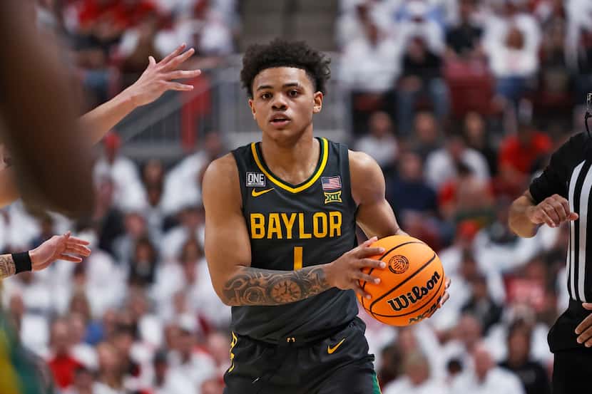 Baylor's Keyonte George (1) passes the ball during the second half of an NCAA college...