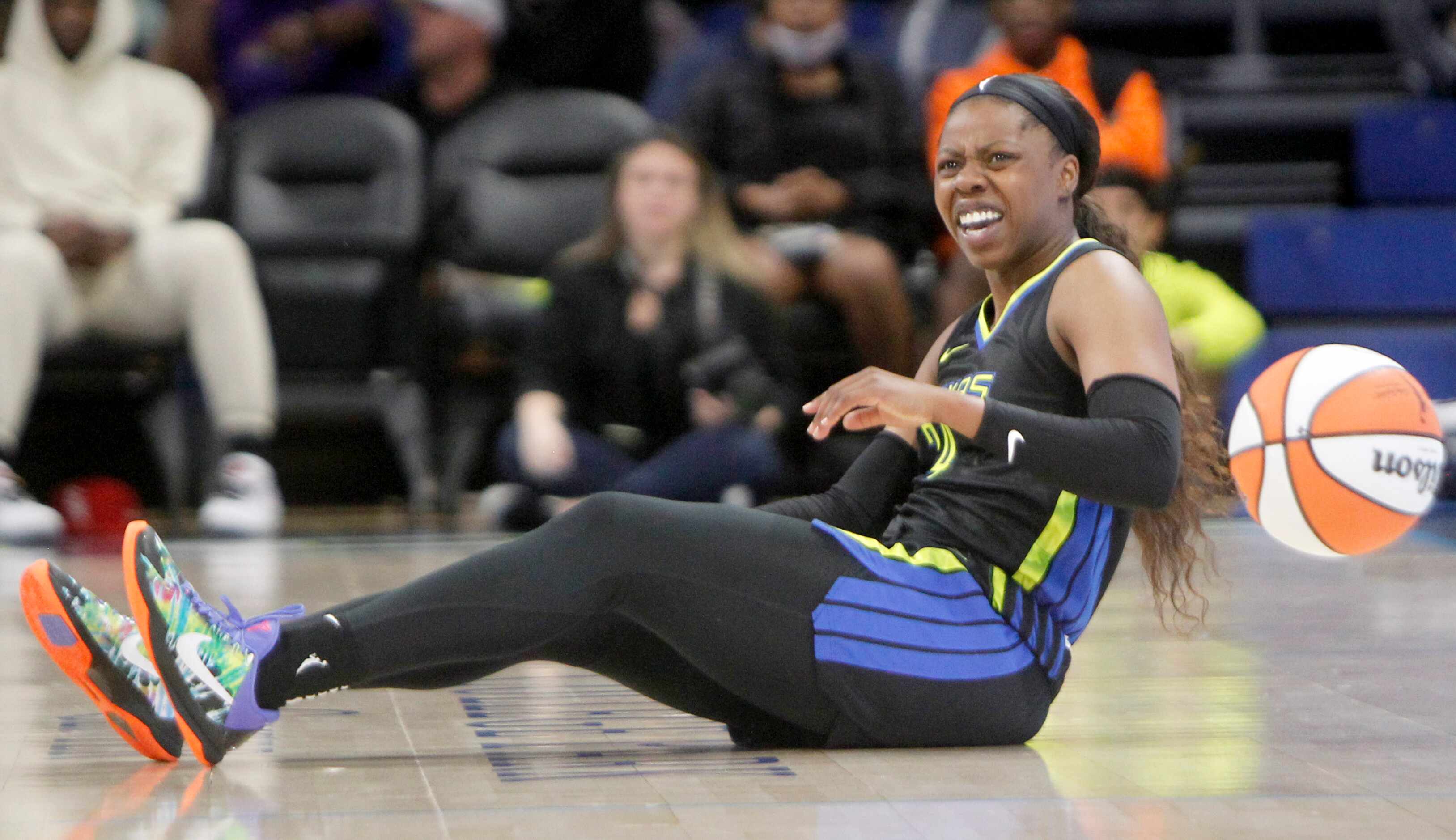 Dallas Wings guard Arike Ogunbowale (24) reacts after a collision with a Minnesota Lynx...
