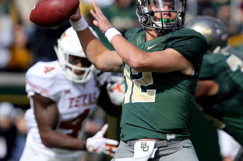 FILE - In this Oct. 28, 2017, file photo, Baylor quarterback Charlie Brewer throws downfield...