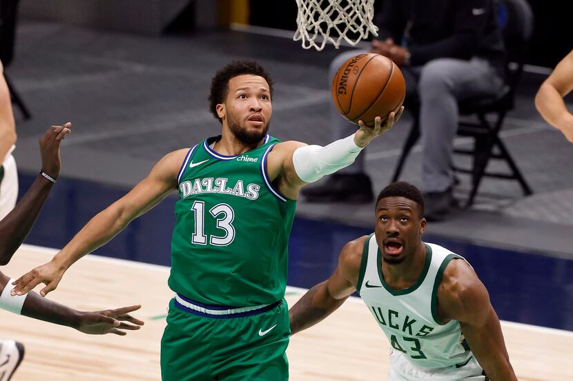 Dallas Mavericks guard Jalen Brunson (13) makes a running layup past Milwaukee Bucks forward...