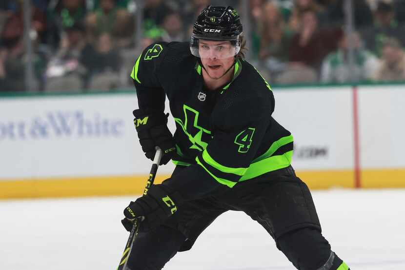 Dallas Stars defenseman Miro Heiskanen (4) skates the puck up the ice during an NHL game...