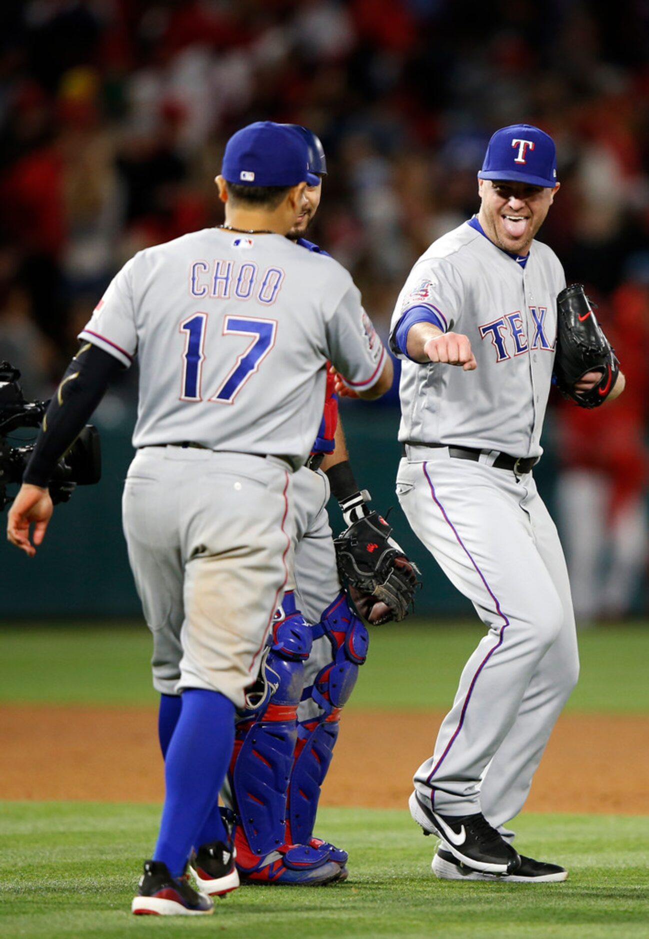 ANAHEIM, CALIFORNIA - MAY 24:  Shin-Soo Choo #17 congratulates Shawn Kelley #27 of the Texas...