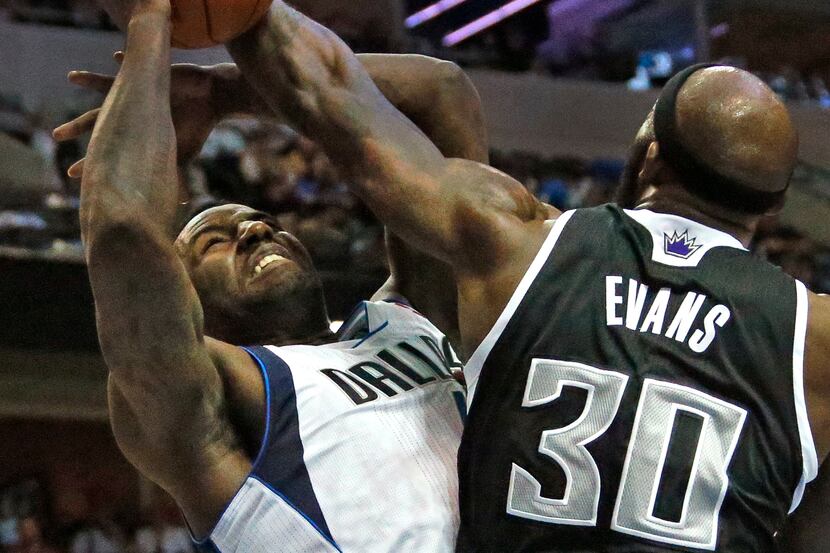 Dallas' DeJuan Blair is fouled by Sacramento's Reggie Evans in the first quarter during the...