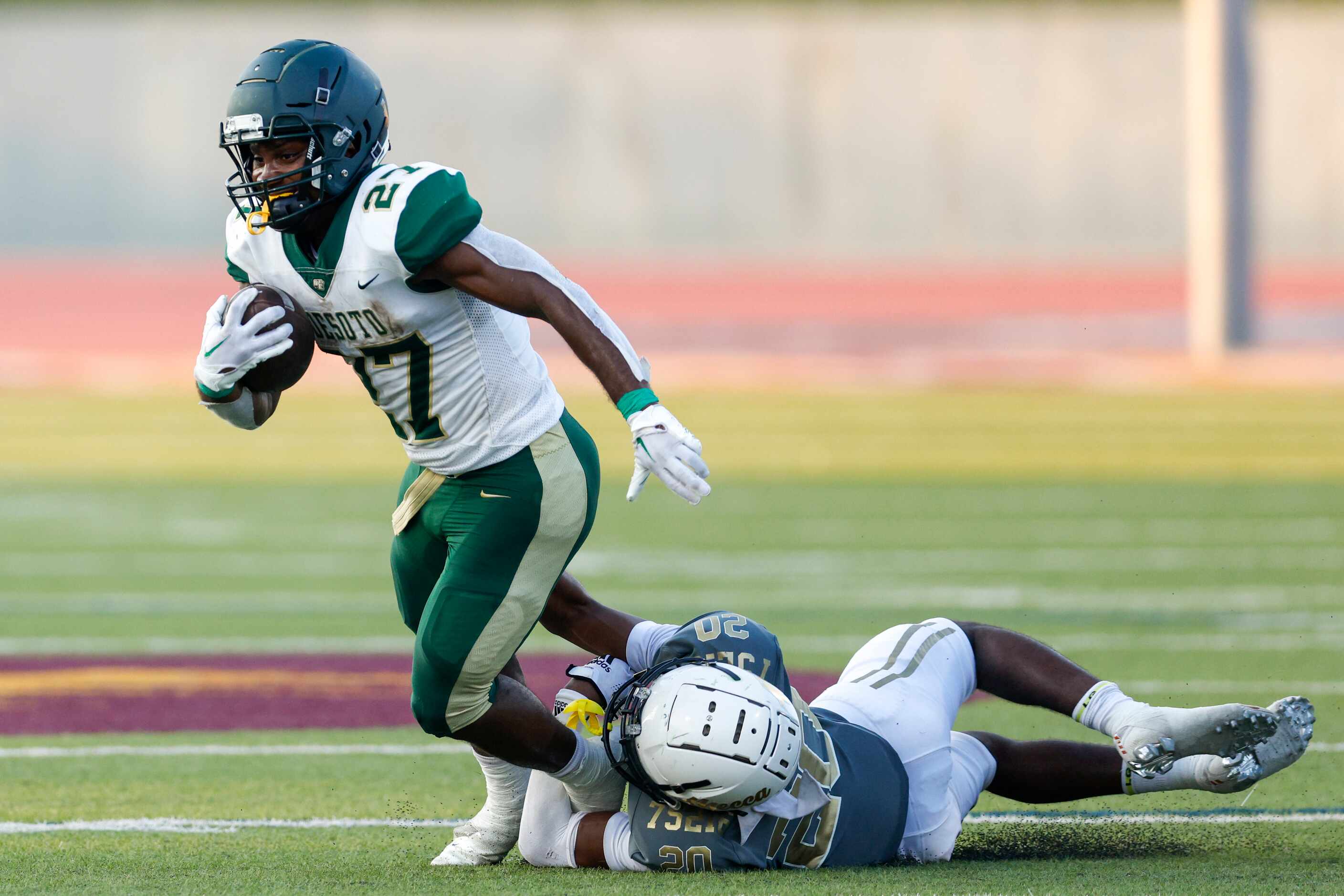 South Oak Cliff defensive back Sultan El-Amin (20) tackles DeSoto running back Marvin Duffey...