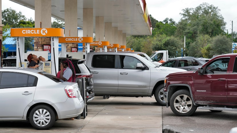 Motorists wait in line to fill gas tanks Monday in Riverview, Fla., before Hurricane Milton...