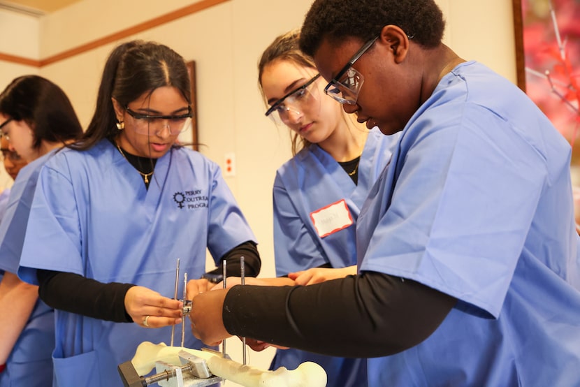 North Texas high schoolers Aanjali Patel (left), Maya Monfared, and Anatopenda Daphrose...