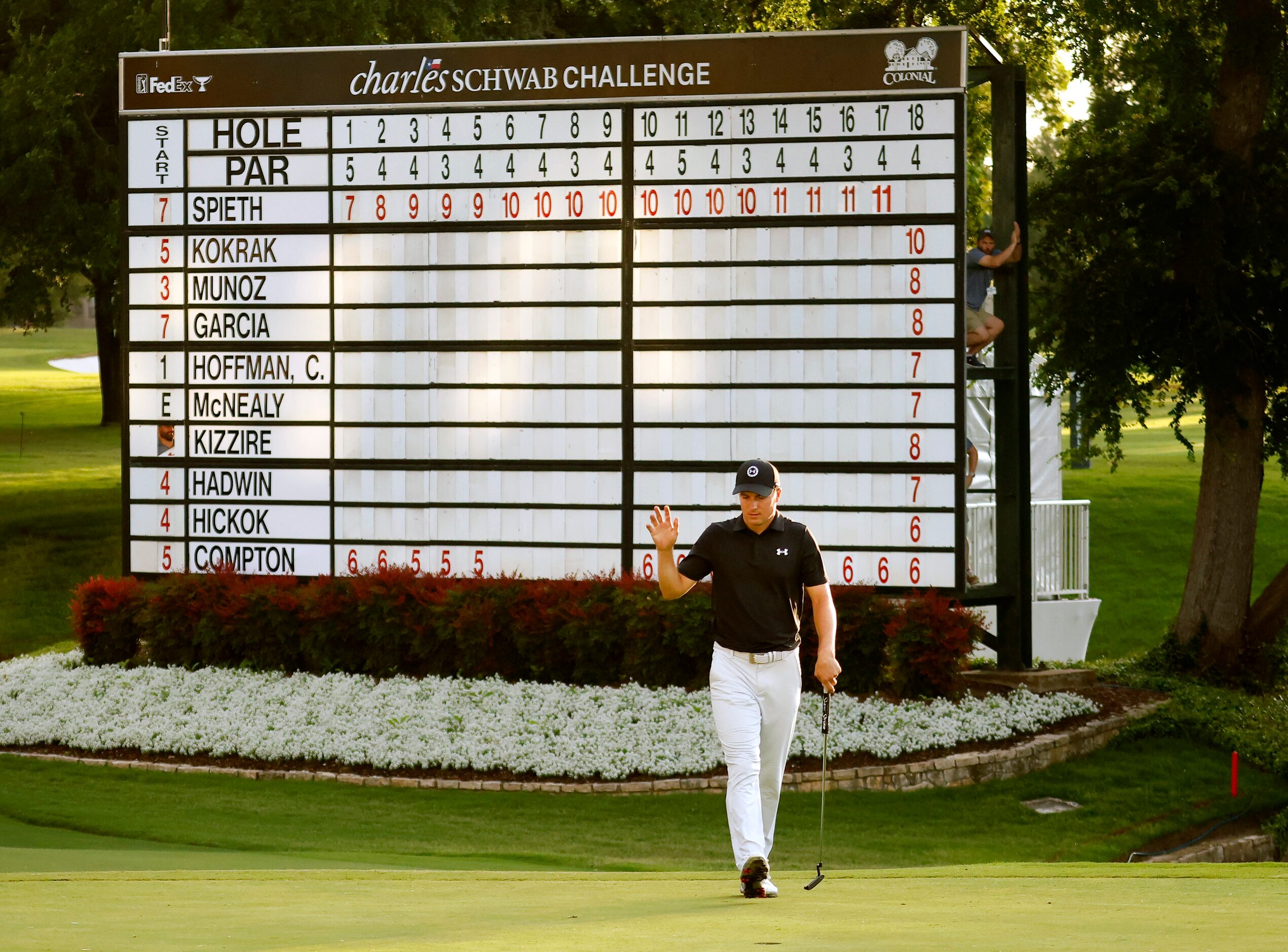 Professional golfer Jordan Spieth waves after making par on No. 18 at the Charles Schwab...