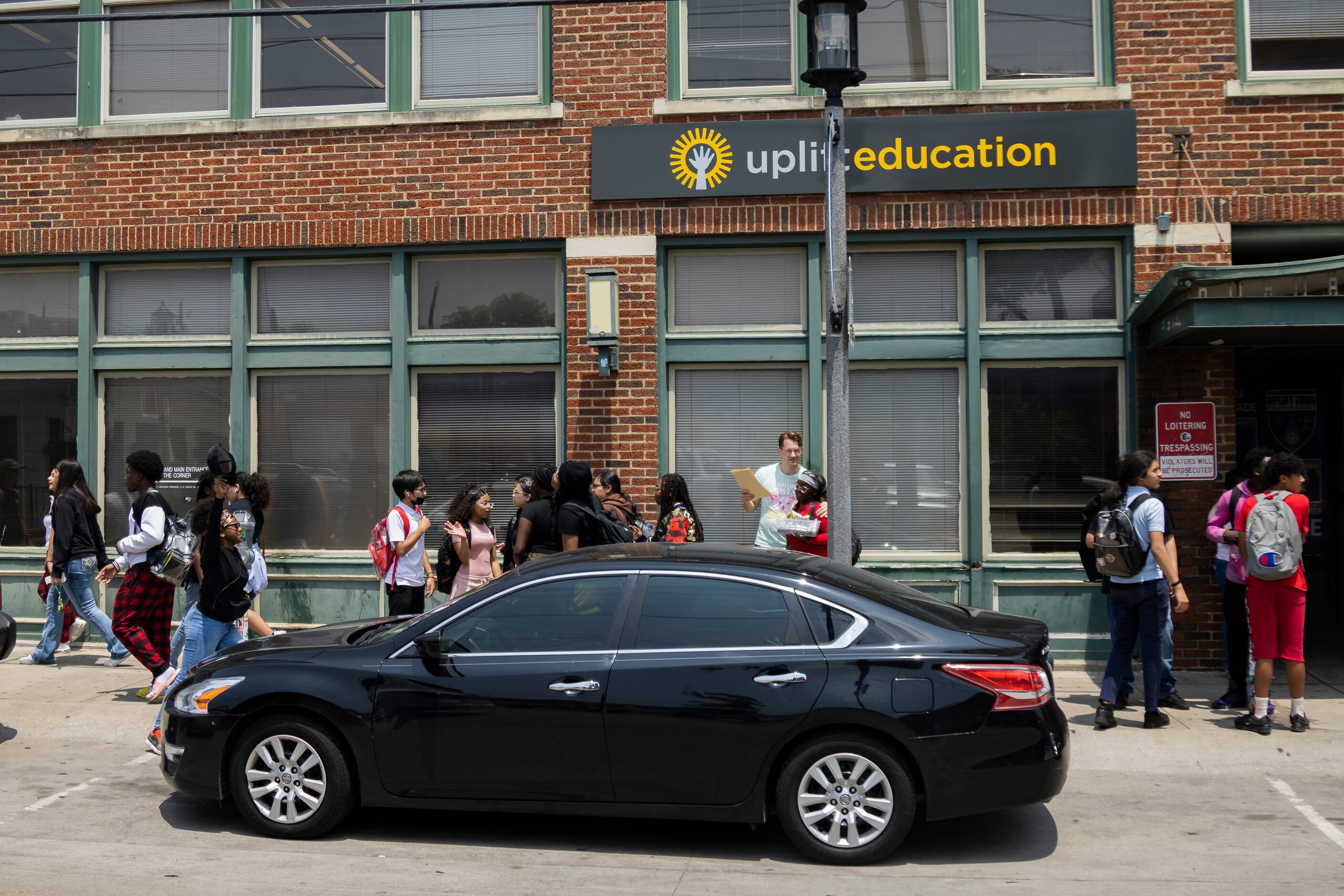 Students from Uplift Luna Preparatory School pour out onto the street as school is let out...