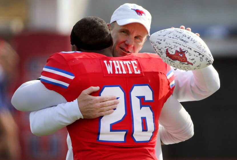 SMU head coach Chad Morris gives a hug to senior linebacker Jeremy White (26) before an NCAA...