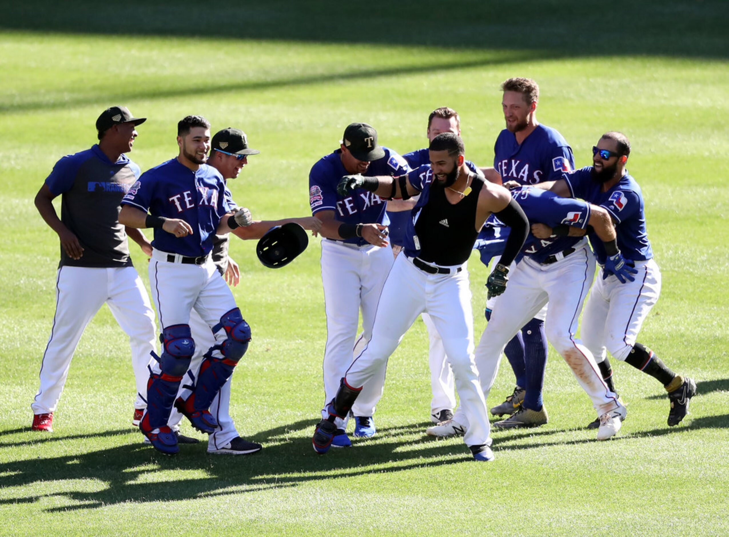 ARLINGTON, TEXAS - MAY 19:  The Texas Rangers celebrate the game winning run scored on a...