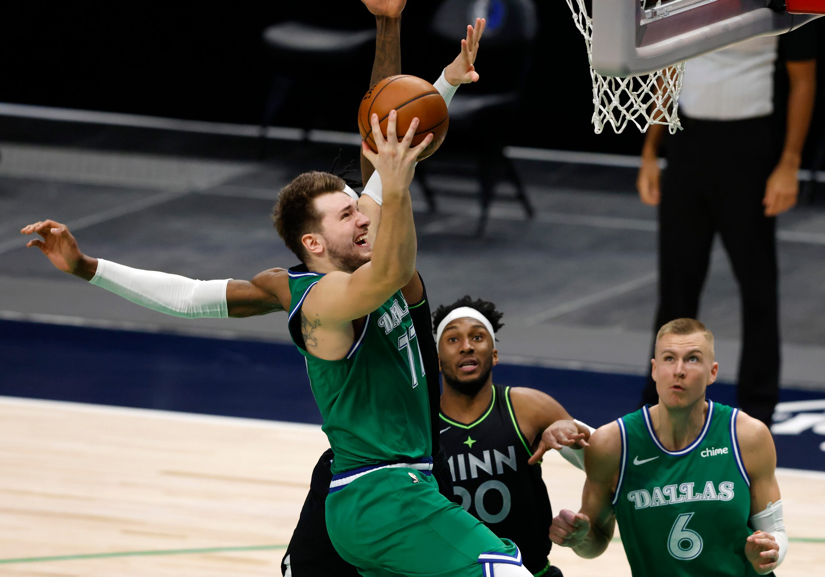 Dallas Mavericks guard Luka Doncic (77) attempts a layup in front of Minnesota Timberwolves...