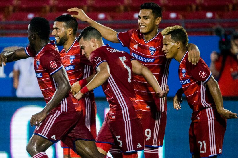 FC Dallas midfielder Javier Morales (11, second from left) and his teammates celebrates a...