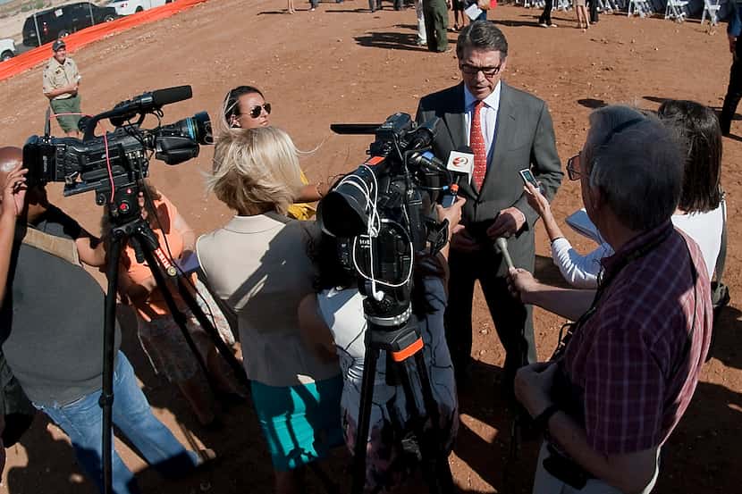 Texas Gov. Rick Perry speaks to the media Tuesday Aug. 26, 2014, following the ground...