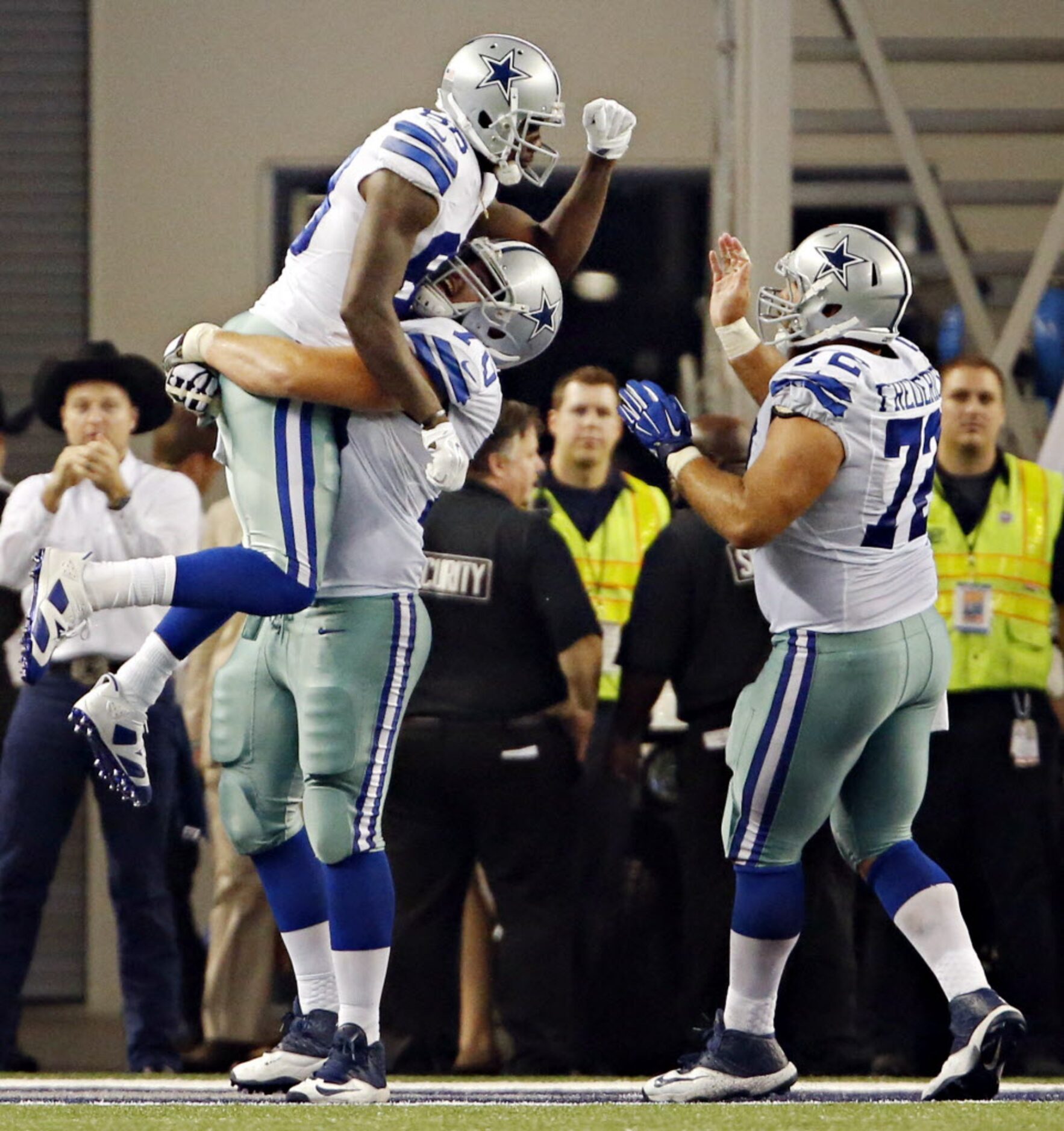 Dallas Cowboys guard Zack Martin (70) hoists Dallas Cowboys wide receiver Dez Bryant (88)...