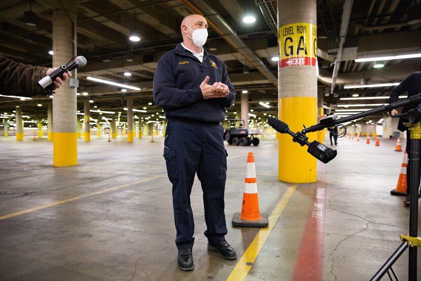 Scott Pacot, Battalion Chief with Dallas Fire-Rescue, talks to the media about the drive-up...