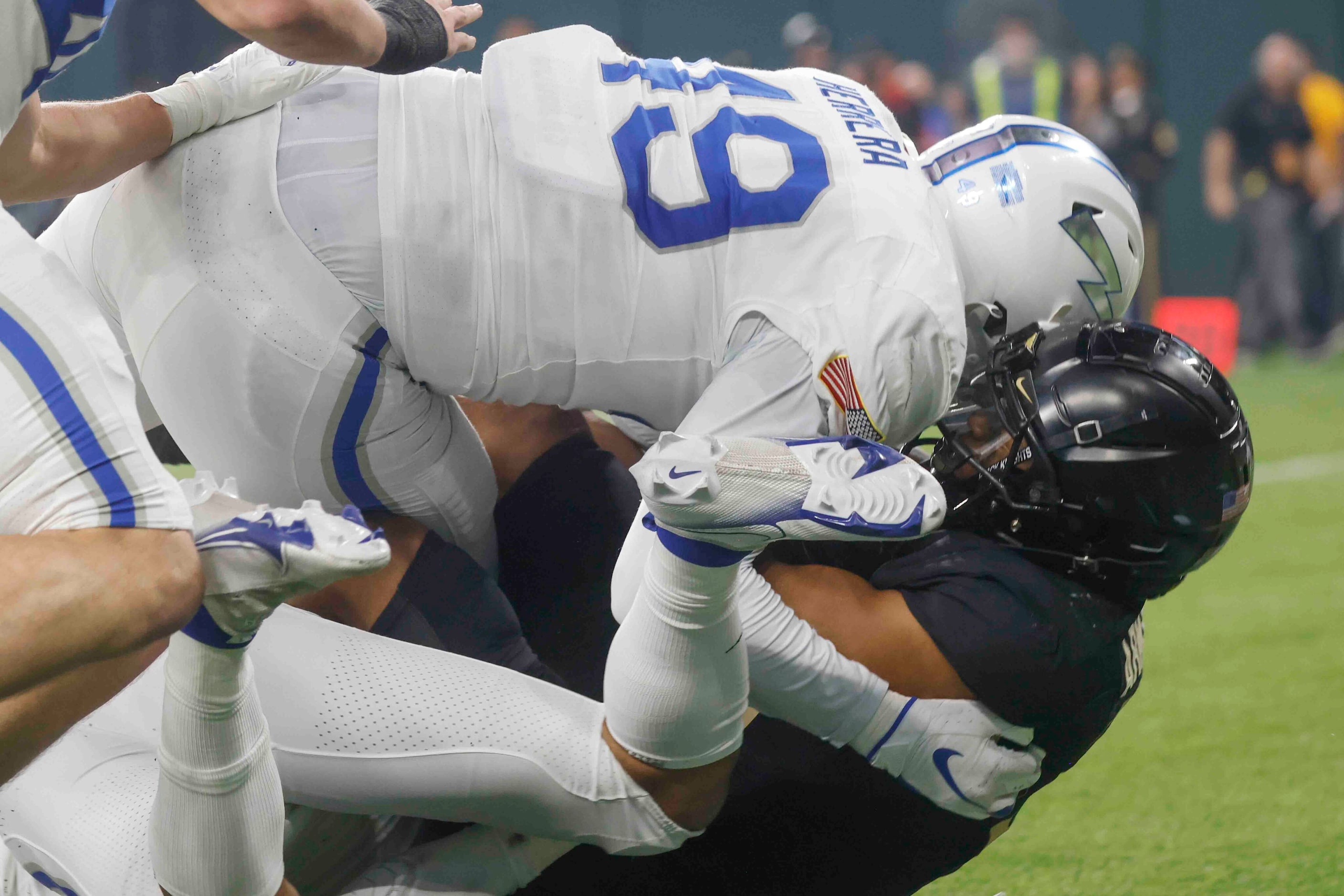 Army running back Ay'Jaun Marshall (3), right, gets tackled by Air Force defensive end...