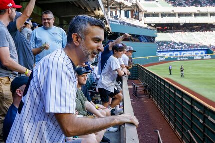 Ashin “Shane” Rangani watches the dot race during a game between the Texas Rangers and the...